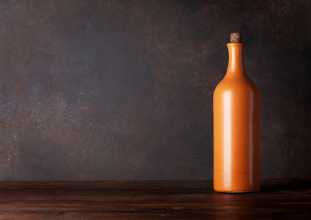 Red wine bottle in front of blackboard wall. With copy space for your textの写真素材