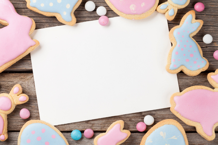 Easter gingerbread cookies on wooden table. Rabbits and eggs. Greeting card. Top view with space for your greetingsの写真素材