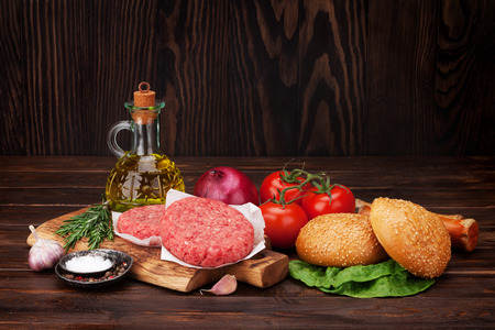 Tasty grilled home made burgers cooking with beef, tomato, cheese, cucumber and lettuceの写真素材