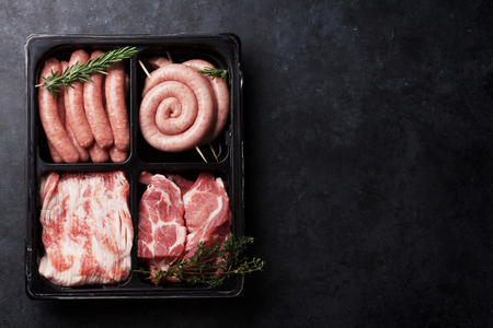 Raw meat and sausages. Top view with space for your textの写真素材