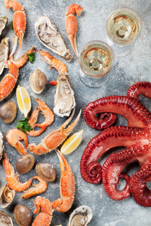 Seafood and wine. Octopus, oysters, lobster, shrimps, clams cooking. Top viewの写真素材