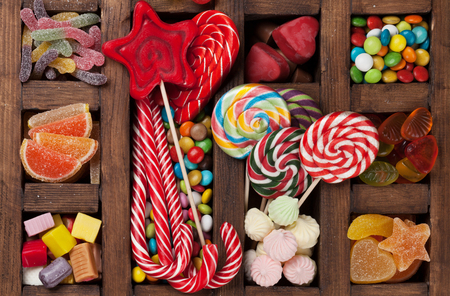 Colorful sweets box. Lollipops, macaroons, marshmallow, marmalade and candies. Top viewの写真素材