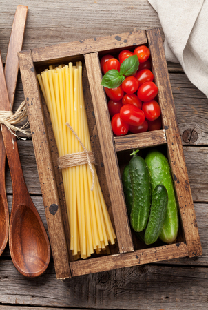 Pasta and ingredients. Tomato, basil, cucumber. Cooking concept. Top viewの写真素材