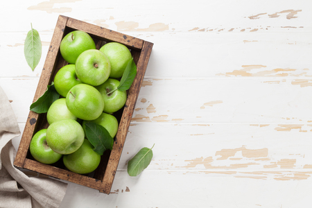 Ripe green apples in wooden box. Top view with space for your textの写真素材