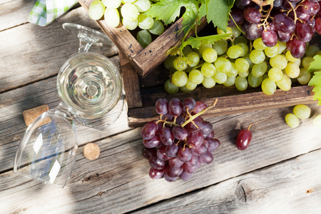 White wine and grape on wooden table. Outdoor still life