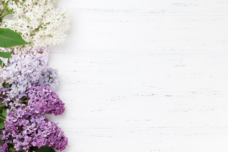 Colorful lilac flowers over wooden background. Top view with space for your textの写真素材