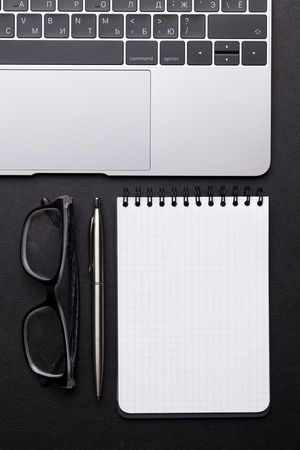 Office workplace table with supplies and laptop. Flat lay. Top view with space for your textの写真素材