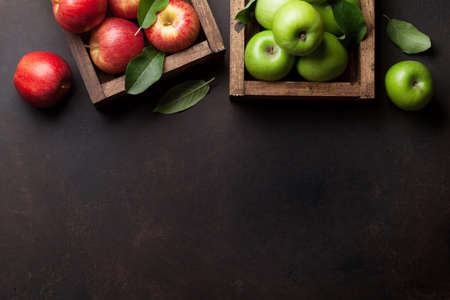 Ripe green and red apples in wooden box. Top view with space for your text
