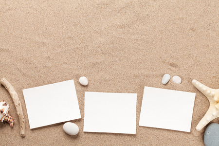 Travel vacation background concept with seashells and photo frames on sand backdrop. Top view with copy space. Flat layの写真素材