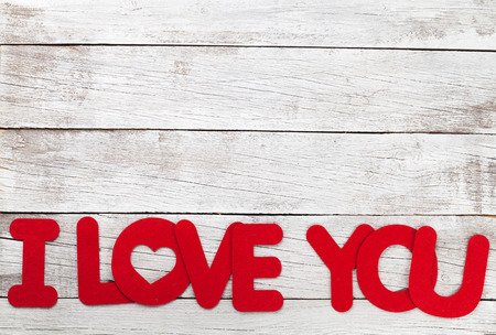 Valentines day greeting card with I love you words over wooden background. With space for your greetingsの写真素材