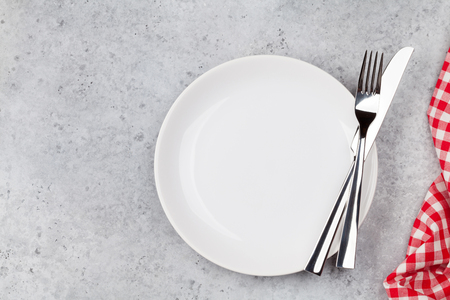 Table setting. Empty plate, knife, fork and napkin. Top view and flat lay with copy spaceの写真素材