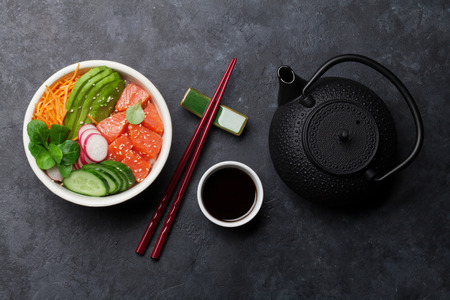 Poke bowl with salmon and vegetables. Traditional Hawaiian raw fish salad. Top viewの写真素材