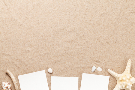 Travel vacation background concept with seashells and photo frames on sand backdrop. Top view with copy space. Flat layの写真素材