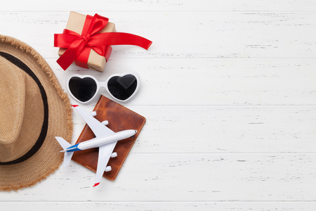 Valentines day travel. Vacation items and accessories on wooden background. Top view with space for your textの写真素材