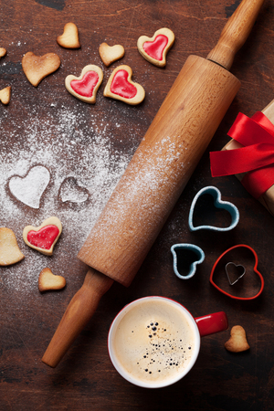 Valentine's day greeting card with cooking heart shaped cookies on wooden background. Top view. Flat layの写真素材