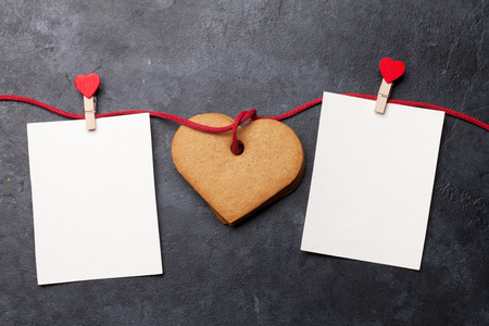Valentine's day greeting card with heart shaped cookies and two frames on stone background. Top view with space for your greetings. Flat layの写真素材