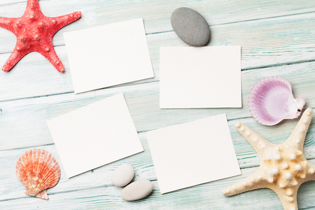 Travel vacation background concept with seashells and photo frames on wooden table. Top view with copy space. Flat layの写真素材