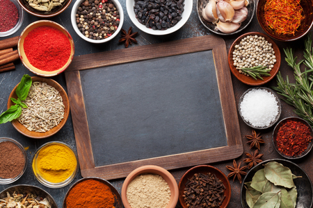 Set of various spices and herbs on stone background. Top view with chalkboard for your recipe. Flat layの写真素材
