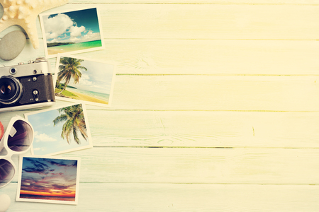 Travel vacation background concept with sunglasses, camera and weekend photos on wooden backdrop. Top view with copy space. Flat lay. All photos taken by me. Sunny tonedの写真素材