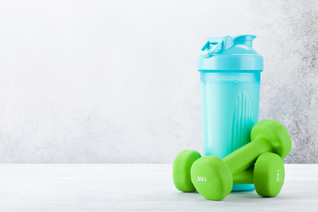 Fitness and healthy food concept. Dumbbells and drink bottle. With copy space for your textの写真素材