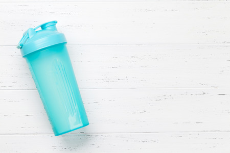 Fitness and healthy food concept. Drink bottle on wooden table. Top view with copy space for your textの写真素材