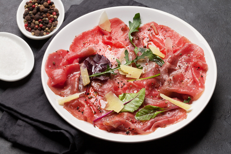 Marbled beef carpaccio with arugula, lemon and parmesan cheeseの写真素材