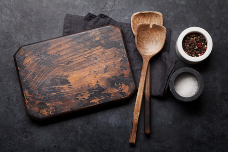 Cooking wooden utensils, cutting board and spices. Food cooking template concept. Top view with copy...