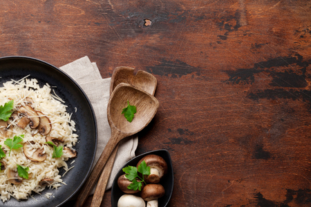 Delicious mushrooms risotto dressed with parmesan cheese and parsley. Top view with copy spaceの写真素材