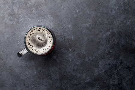 Glass of dark porter beer on stone table. Top view flat lay with copy space