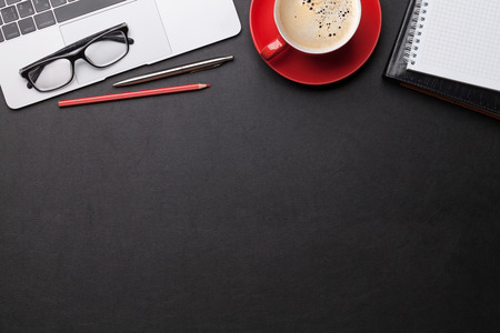 Office workplace table with coffee cup, supplies and computer Flat lay. Top view with space for your...