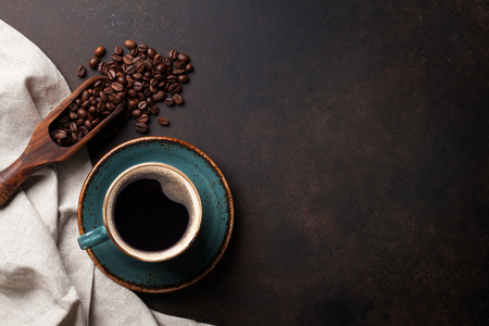 Coffee cup and beans on old kitchen table. Top view with copyspace for your textの写真素材