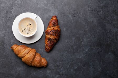 Coffee and croissant on stone table. French breakfast. Top view flat lay with copy space for your textの写真素材