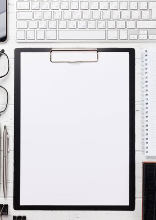 Office workplace table with blank paper page, supplies and computer. Flat lay. Top view with space for your goalsの写真素材