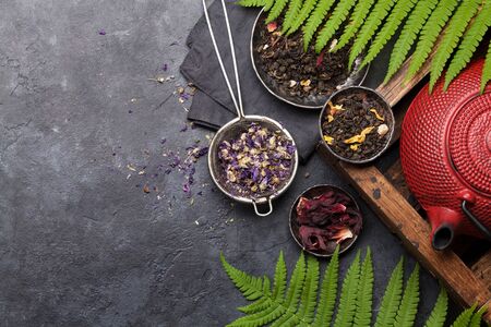 Set of different herbal and fruit dry teas on stone table. Top view flat lay with copy spaceの写真素材