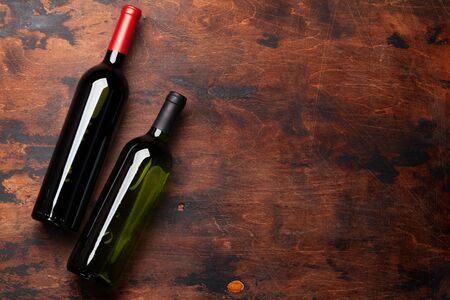 Various wine bottles on wooden table. Red and white wines. Top view flat lay with copy space for your textの写真素材