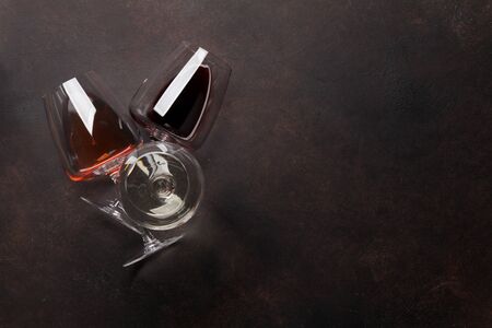 Various wine glasses on stone table. Red, rose and white wines. Top view flat lay with copy space...