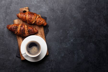 Coffee and croissant on stone table. French breakfast. Top view flat lay with copy space for your textの写真素材