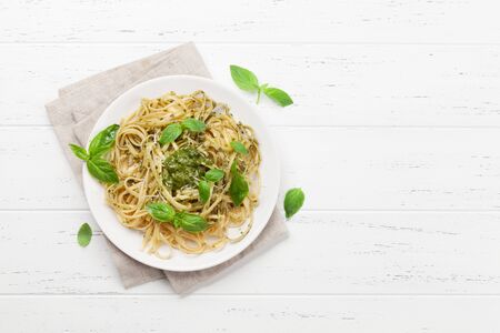 Spaghetti pasta with pesto sauce, parmesan cheese and fresh basil. Top view with copy space for your textの写真素材