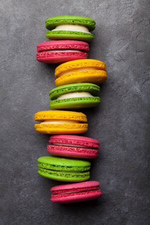 Cake macaron or macaroon sweets on stone backdrop. Top view flat layの写真素材