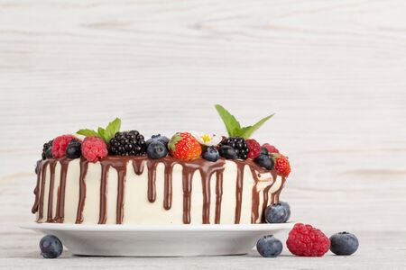 Chocolate cake or cheesecake with berries. On wooden table with copy spaceの写真素材