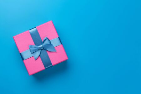 Gift box on blue background. Top view with copy space. Flat layの写真素材