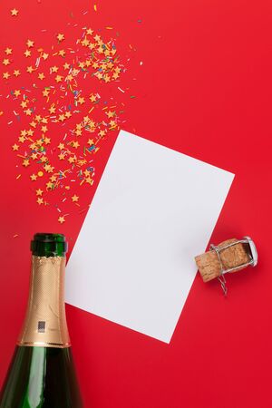 Champagne bottle, blank card and sweets holiday template. Christmas, Birthday or Valentines'day backdrop. Top view with space for your greetingsの写真素材