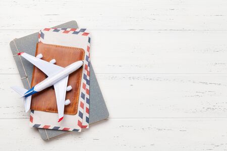 Travel concept with airplane, passport and notepad. Top view flat lay with copy space