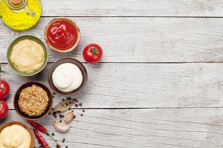 Set of various sauces on white wooden table.の写真素材