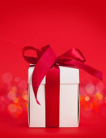Valentines day gift box over red background with bokeh and copy space for your greetingsの写真素材