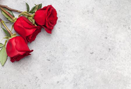 Valentines day greeting card with rose flowers bouquet over stone background with space for your greetings. Top view flat layの写真素材