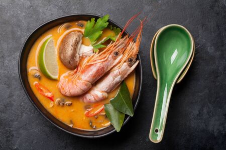 Tom yum traditional thai soup with seafood, mushrooms, coconut milk and hot spices. Top view
