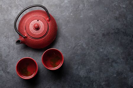 Japanese tea in teapot and cups on stone table. Asian food concept. Top view flat lay with copy spaceの写真素材