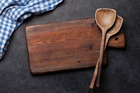 Kitchen table with utensils, cutting board and tablecloth and space for your recipe or menu. Top view flat layの写真素材
