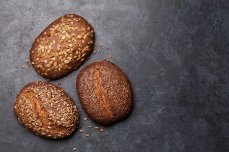 Various homemade bread with seeds on stone table. Top view flat lay with copy spaceの写真素材